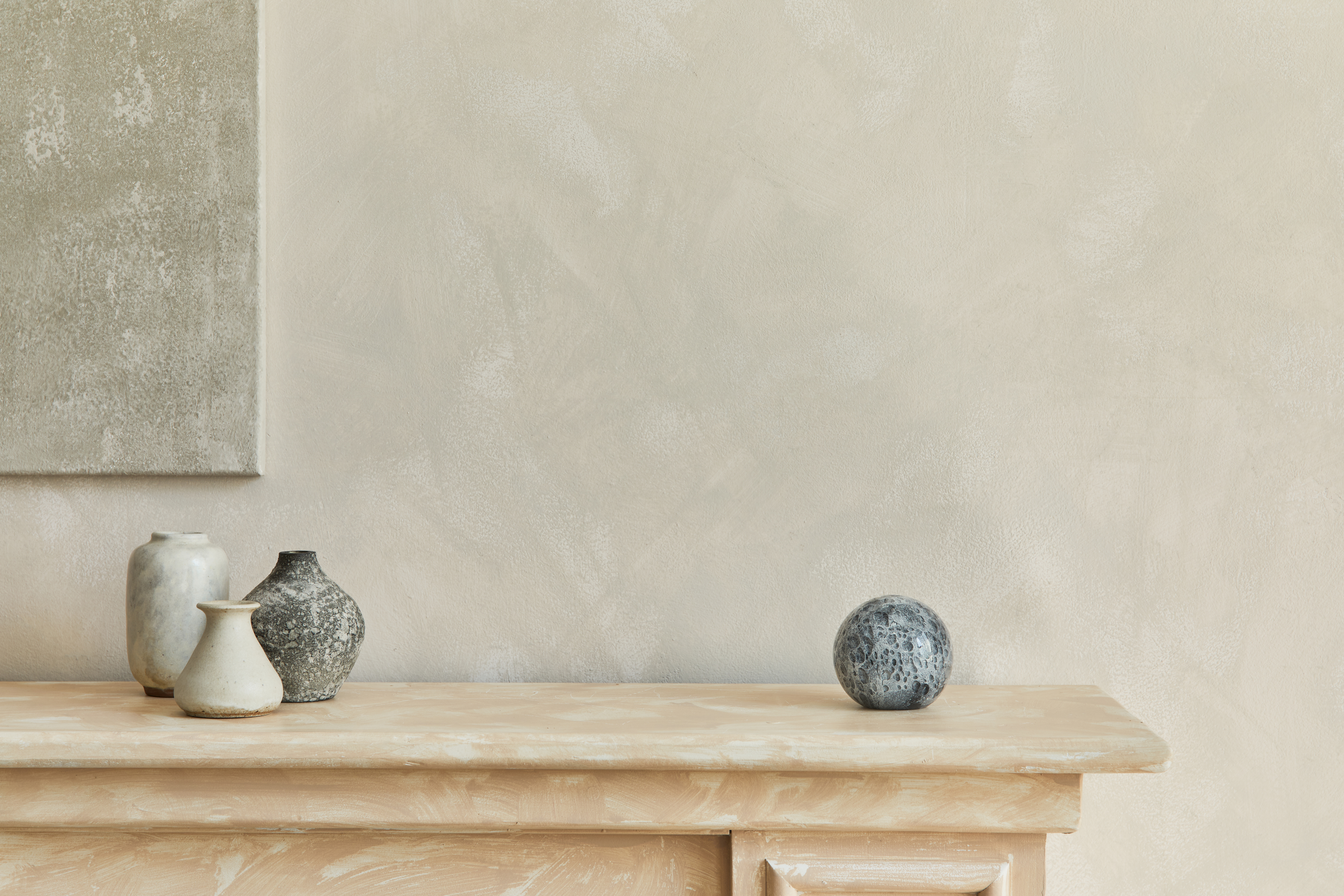 Neutral palette interior with textured limewash walls and ceramic vases — the matte, mineral finish that limewash produces on interior walls